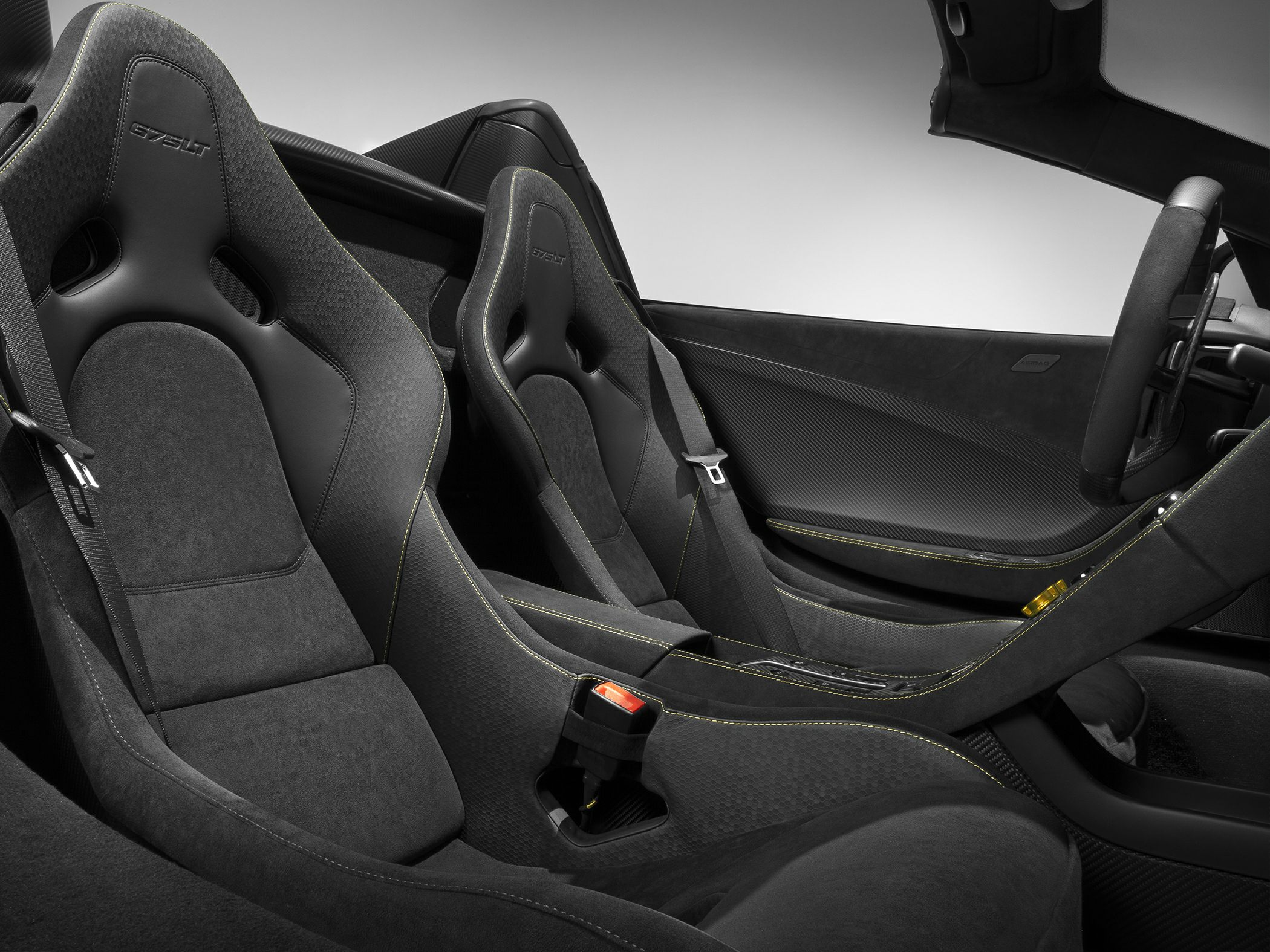 Racing bucket seats with carbon fiber interior and yellow stitching