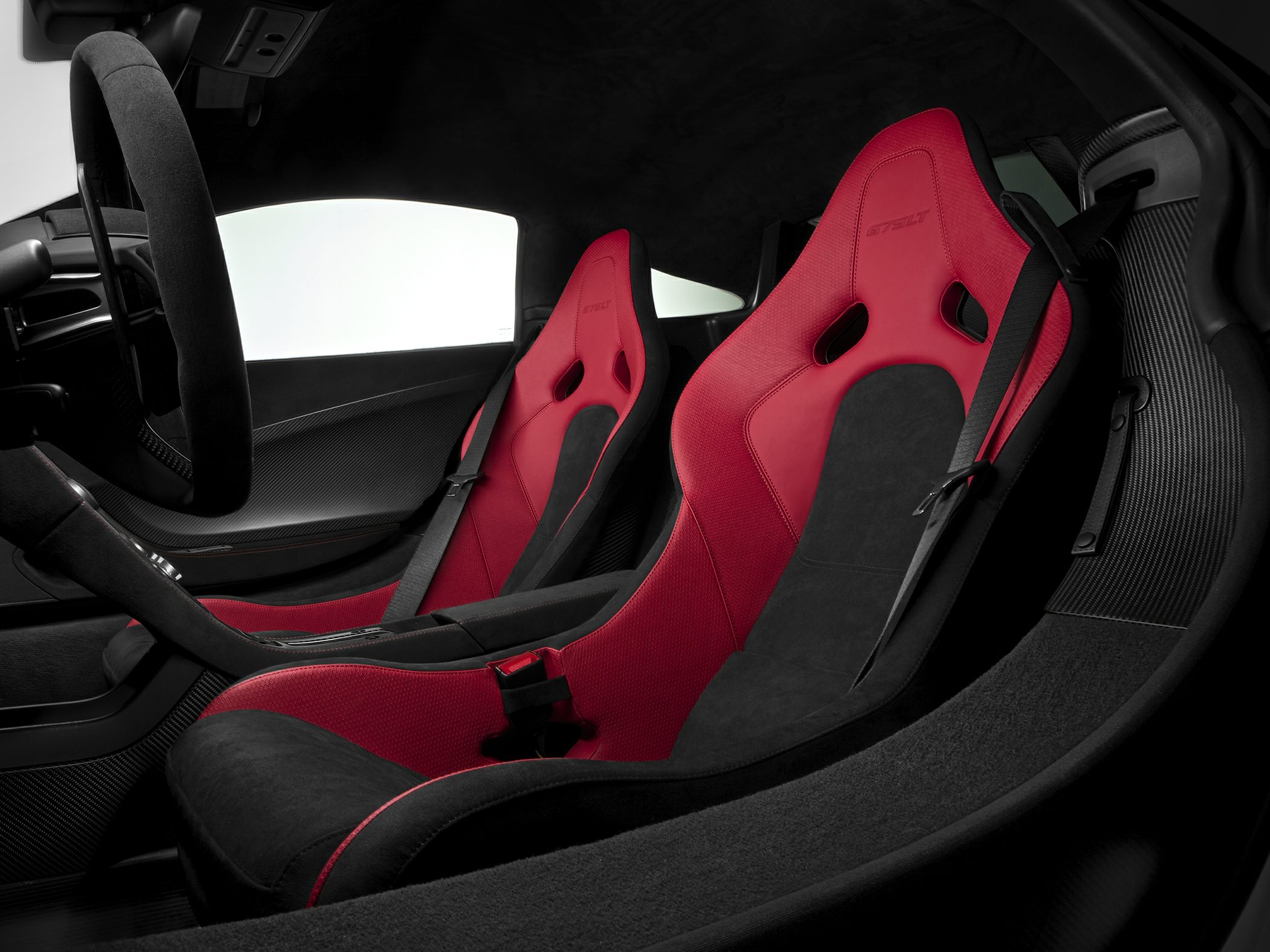Red and black racing bucket seats with carbon fiber accents