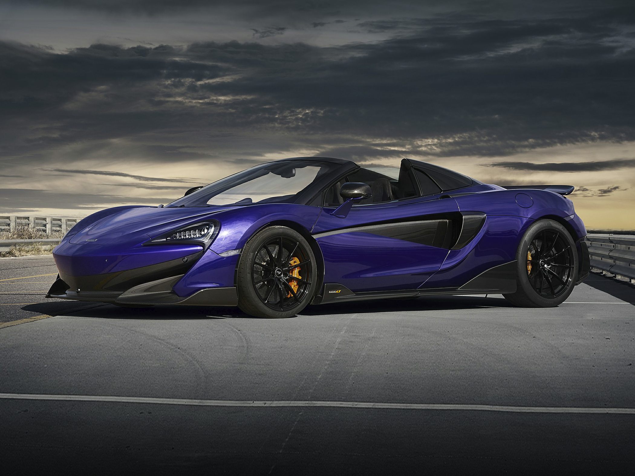 Blue convertible sports car with aerodynamic accents and black wheels