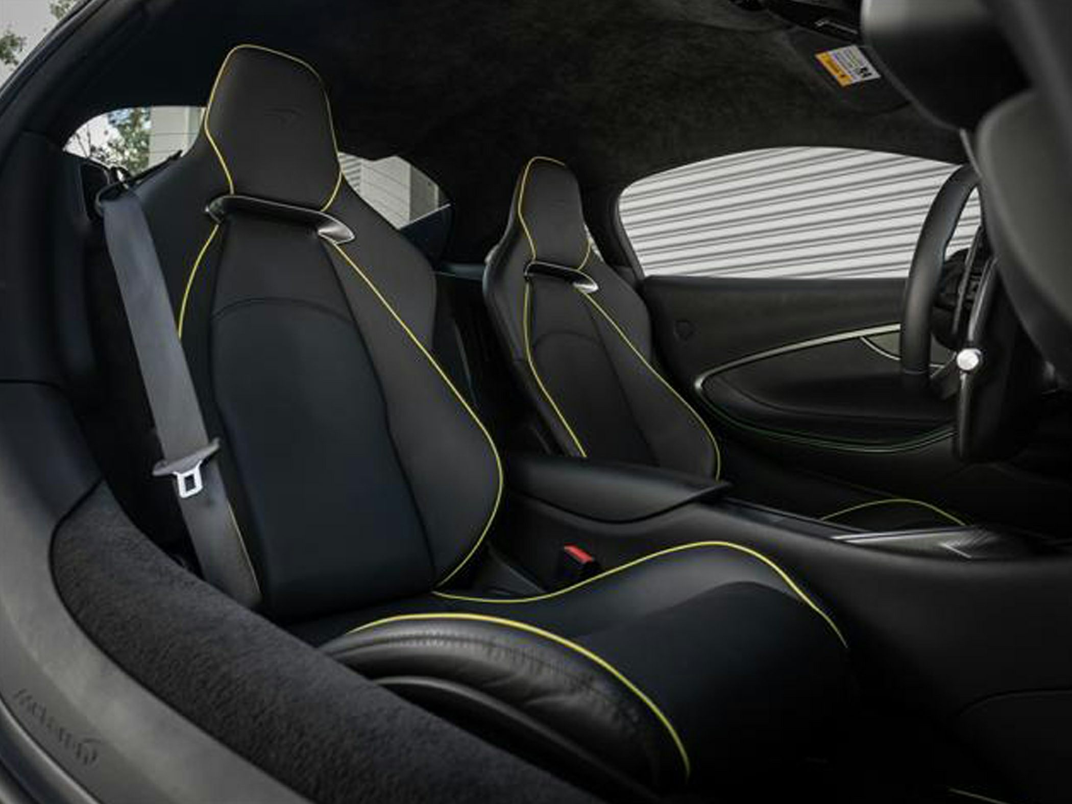 Luxury car seats with yellow stitching and modern design