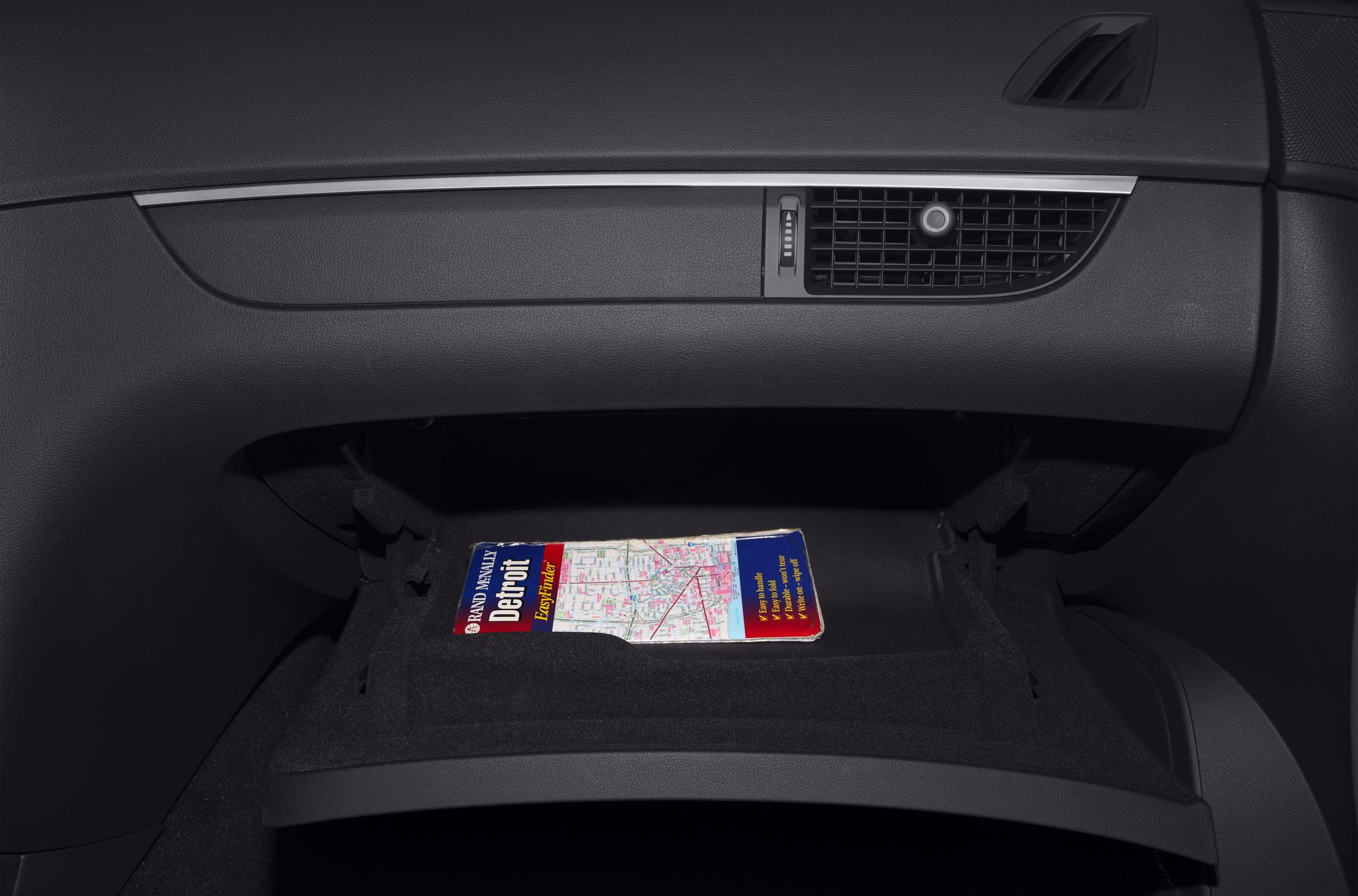 open glove compartment with map inside