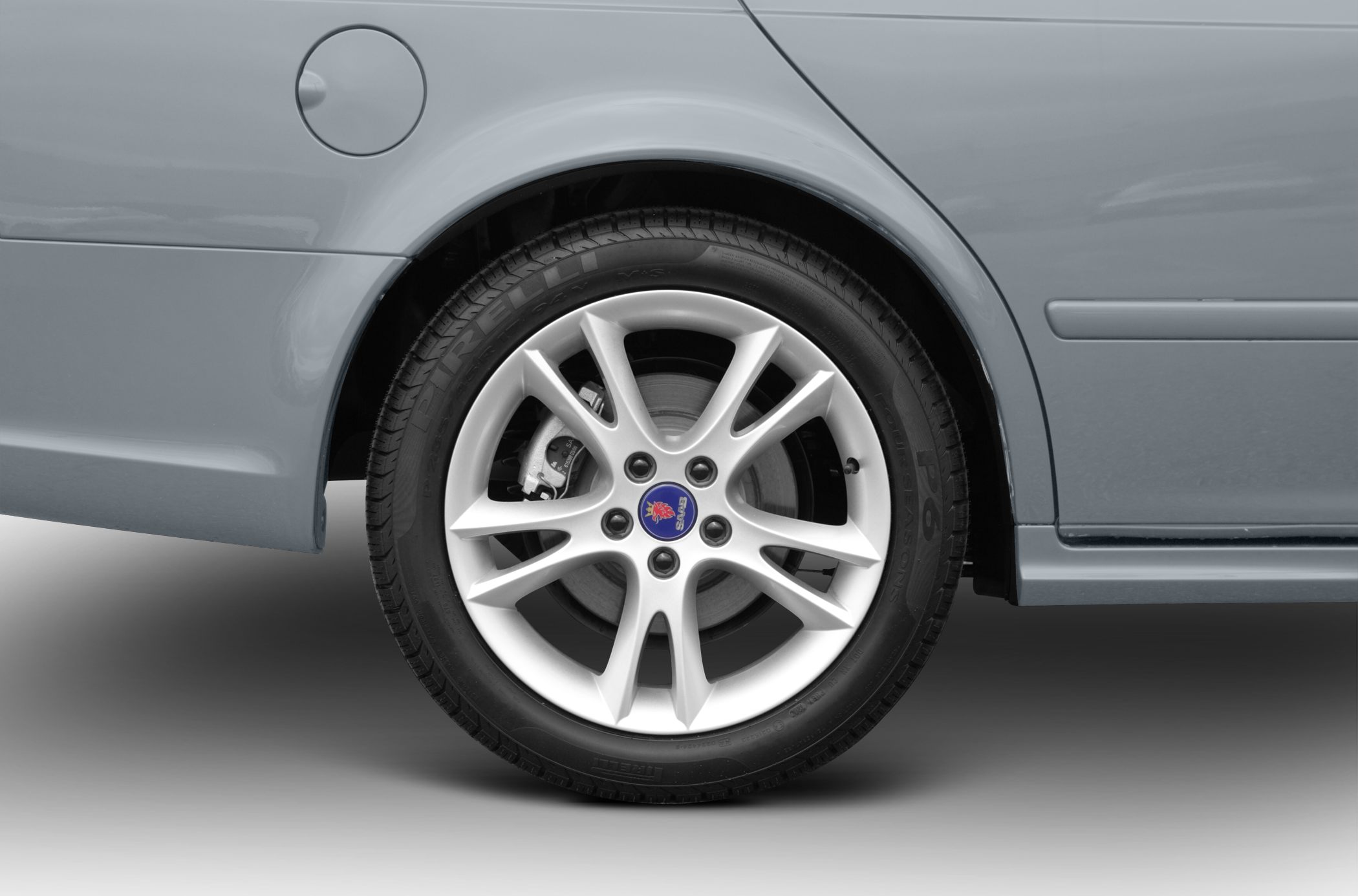 Alloy wheel and rear side panel with fuel cap