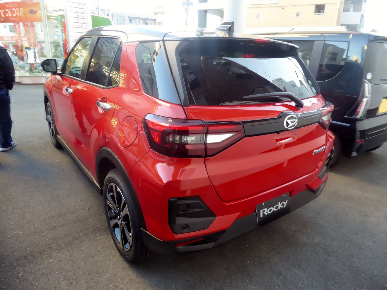 Rear view of a compact SUV with modern taillights and red paint