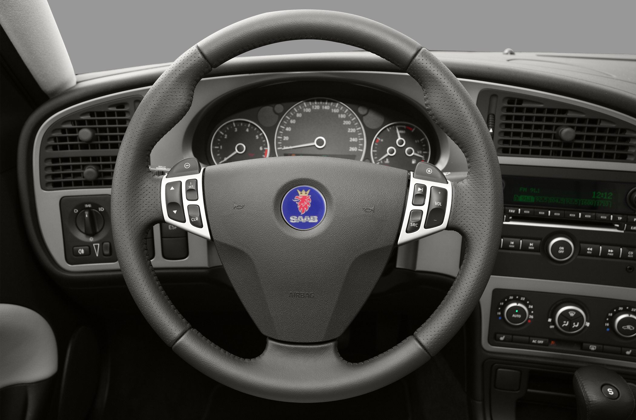 Steering wheel with control buttons and dashboard gauges