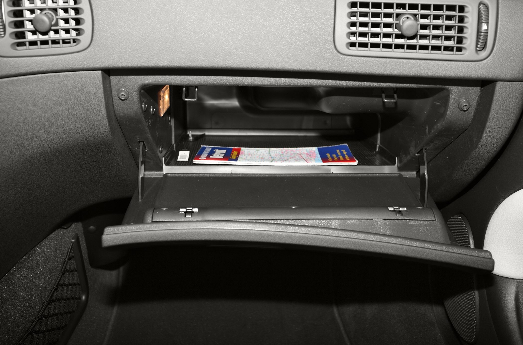 Open glove compartment with map inside