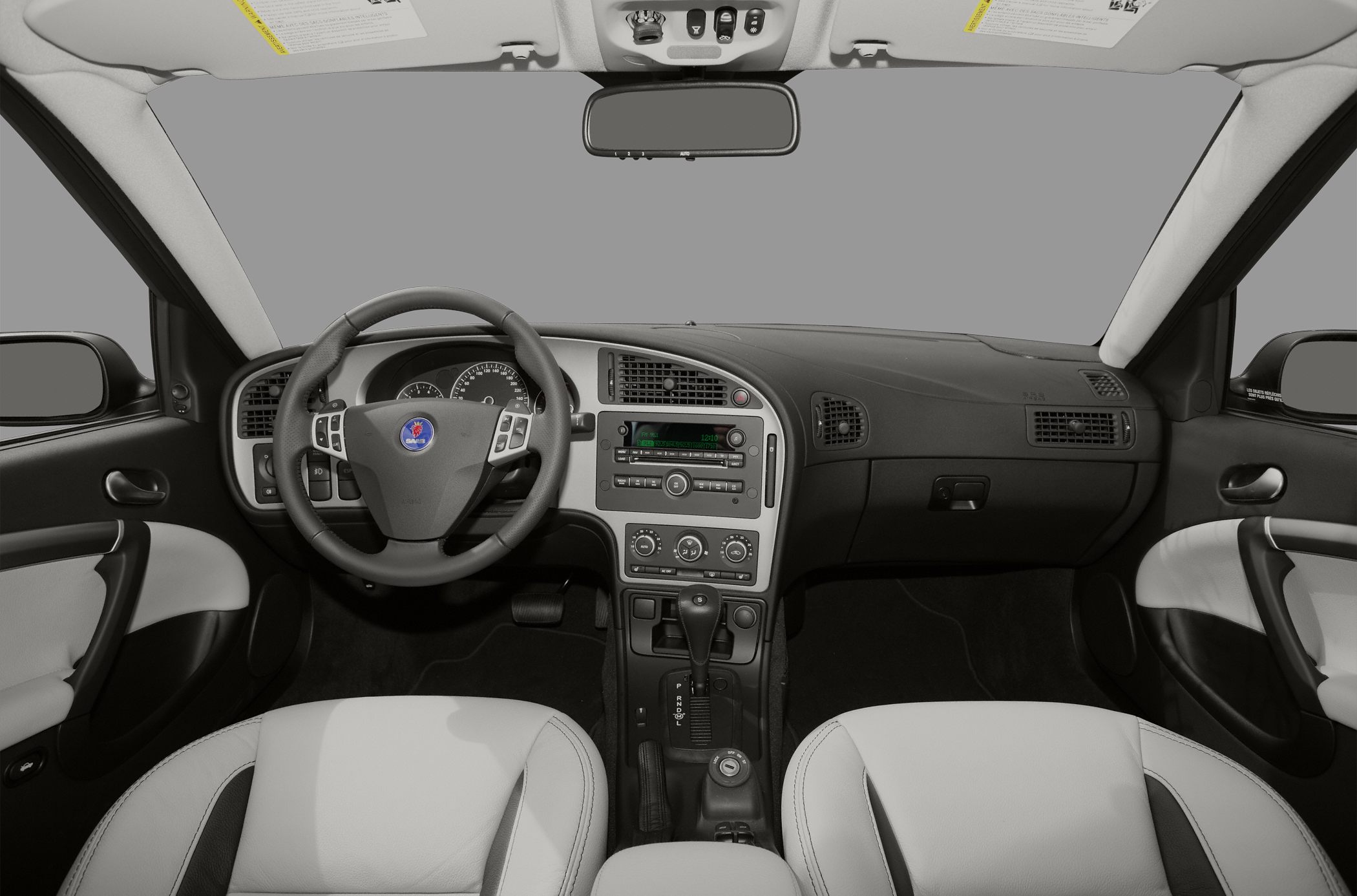 Car interior with dashboard, steering wheel, and center console.