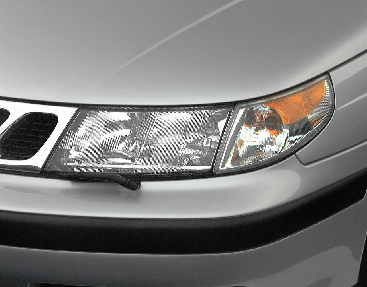 Close-up of integrated headlight assembly with turn signal and grille