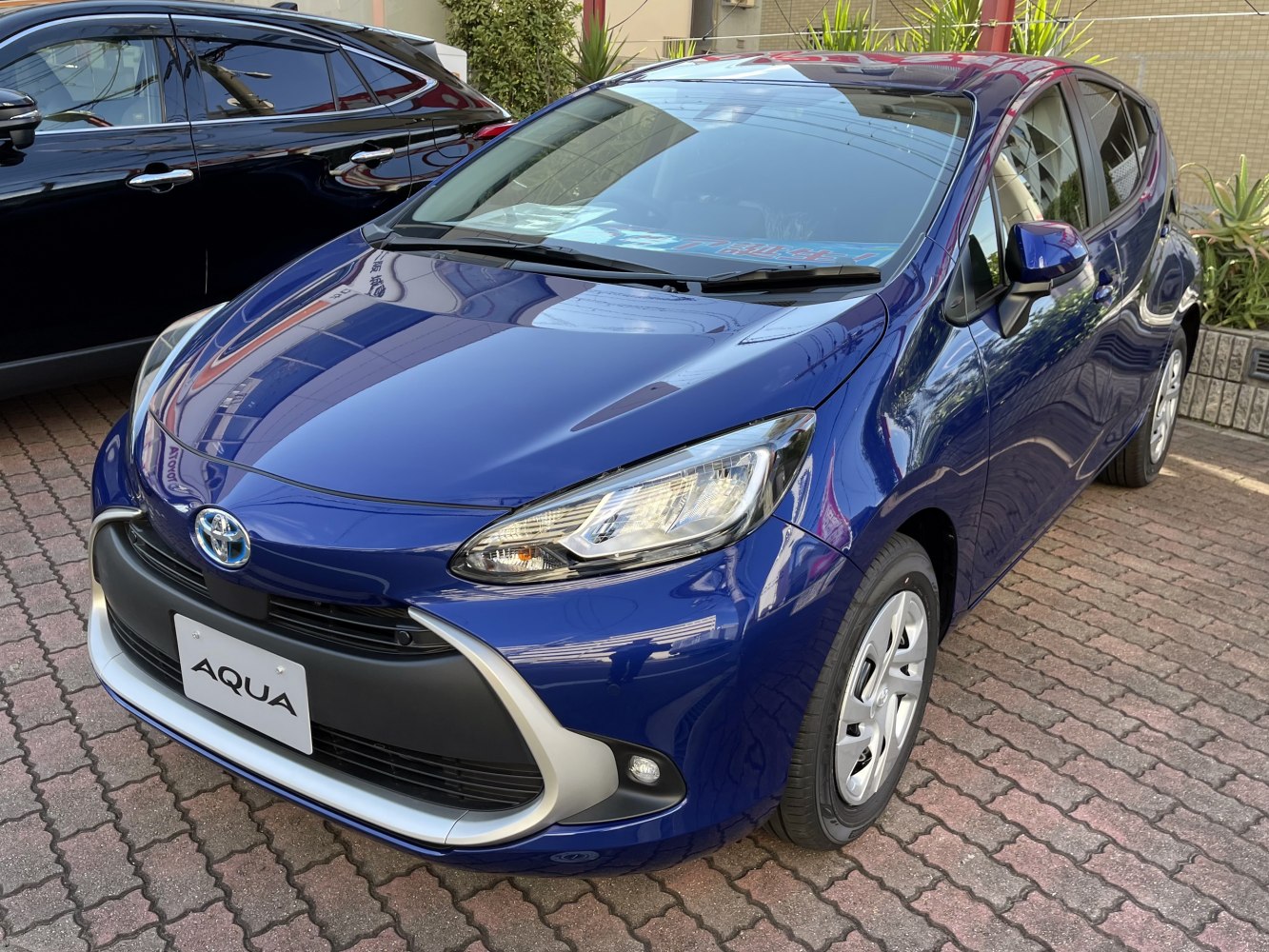 Front view of hybrid hatchback with LED headlights and aerodynamic design