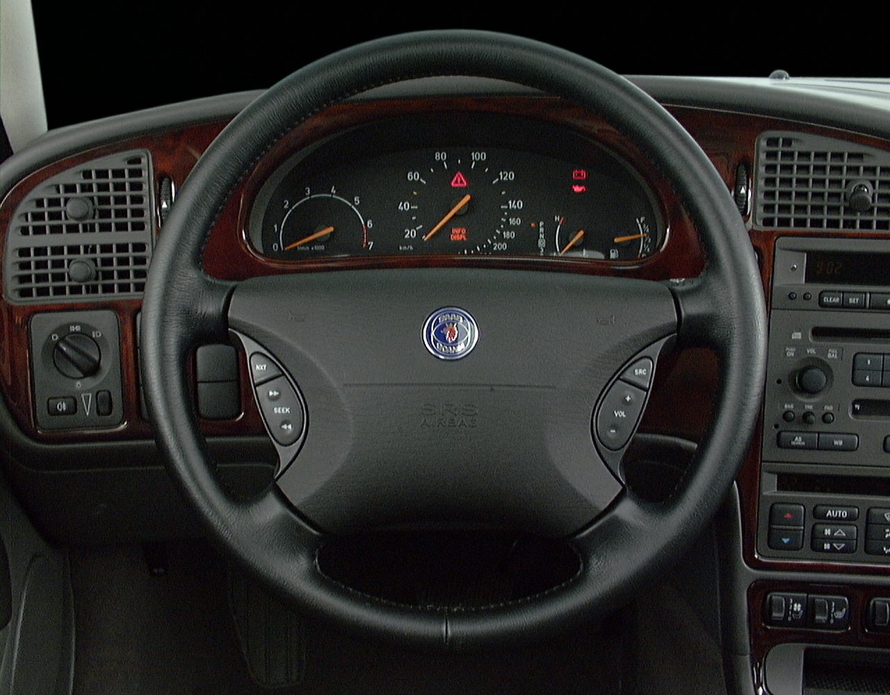 Steering wheel with integrated controls and classic instrument cluster with wood trim