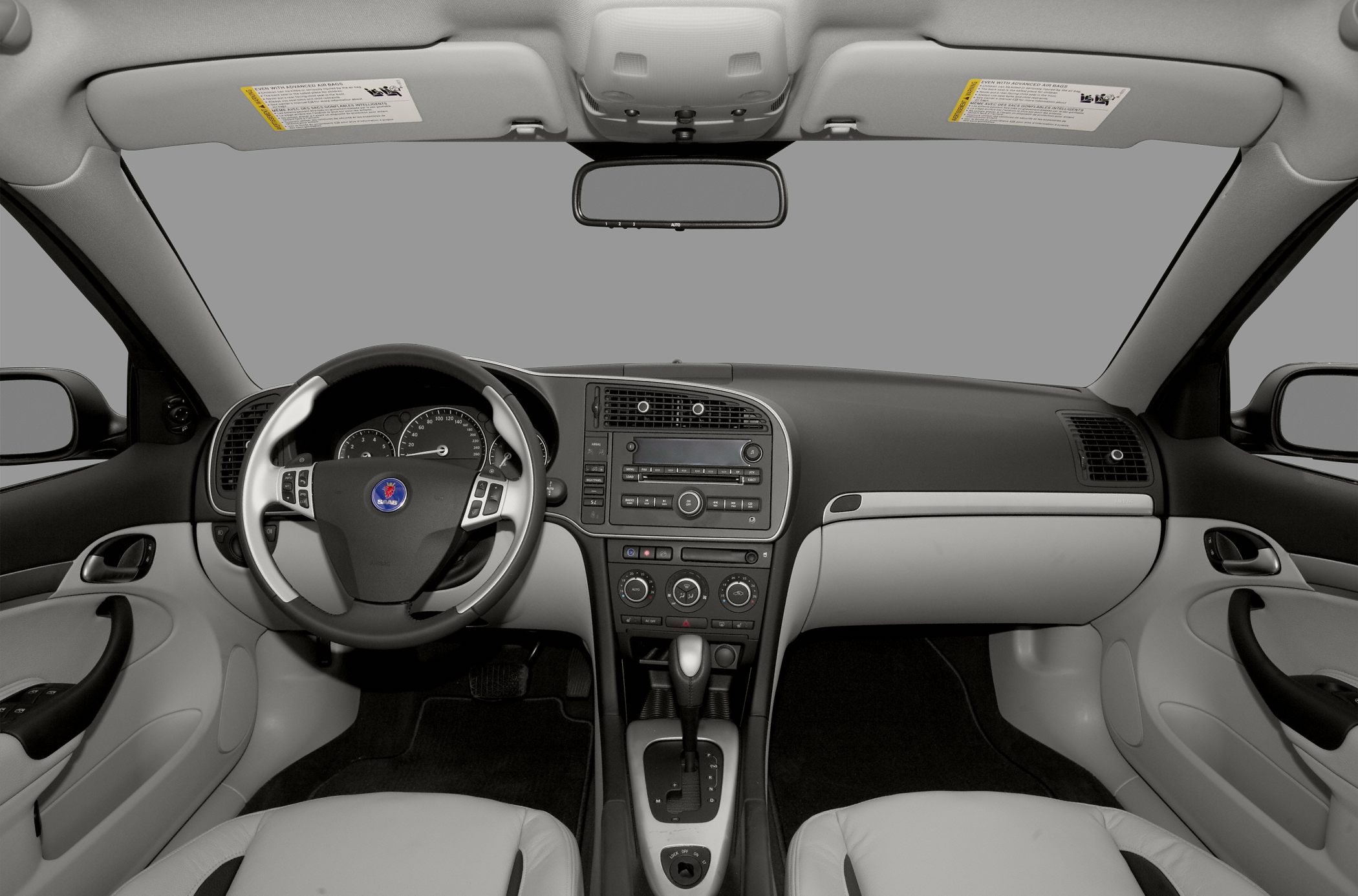 Steering wheel and central dashboard console with gear shifter.