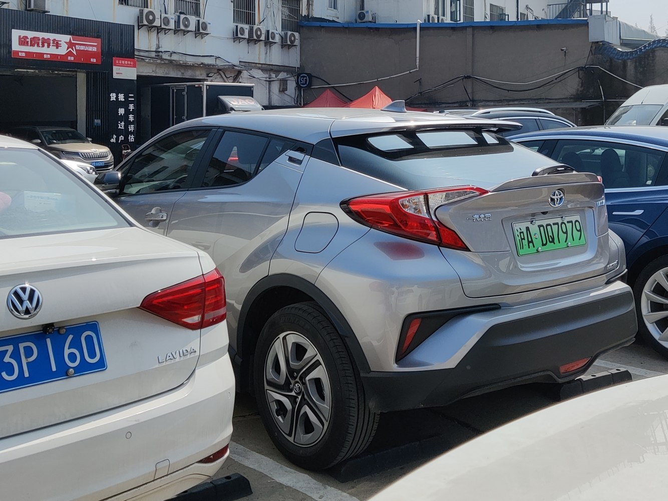 Rear view of a silver compact SUV with sporty spoiler and distinct tail lights