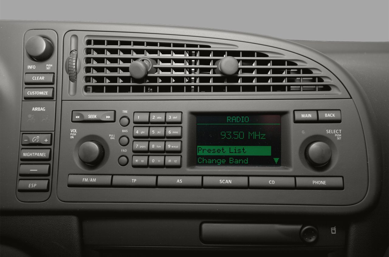 Dashboard radio and climate control vents with vehicle buttons