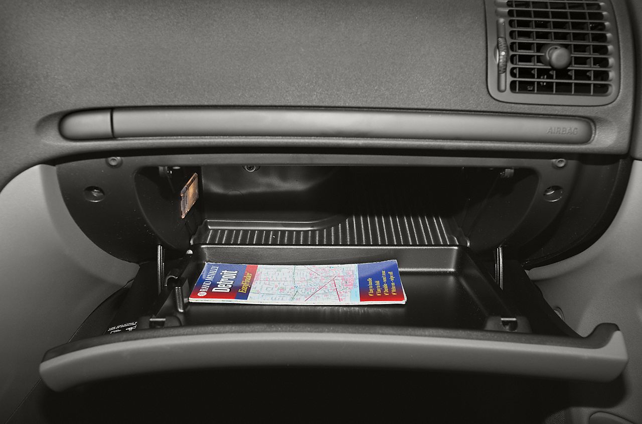 Open glove box in car dashboard with storage space