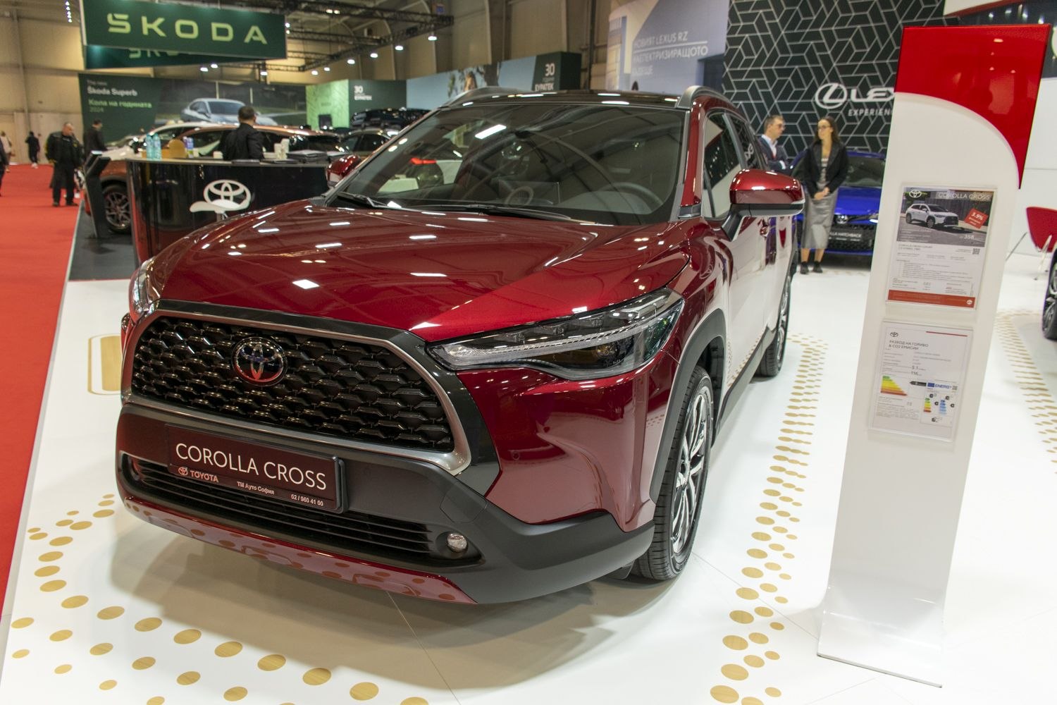 Front view of a dark red SUV with bold grille and LED headlights