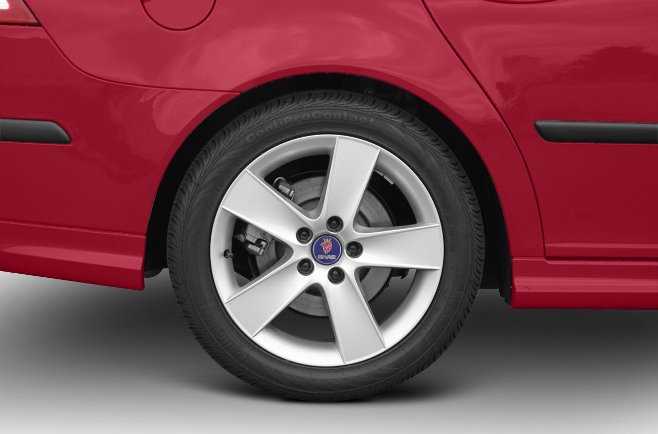 Rear alloy wheel and fender of a red vehicle