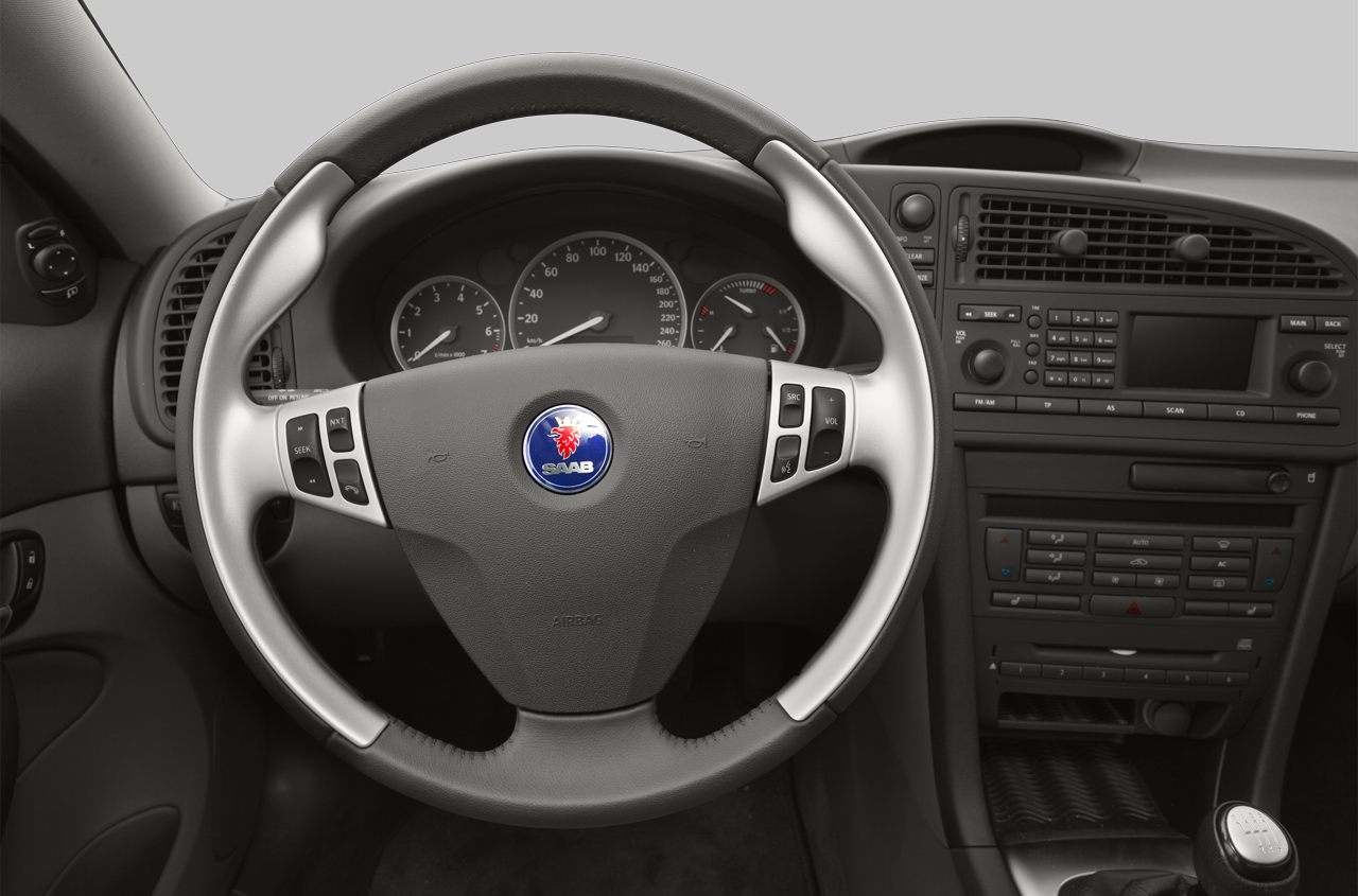 Steering wheel and dashboard interior with instrument cluster and radio controls