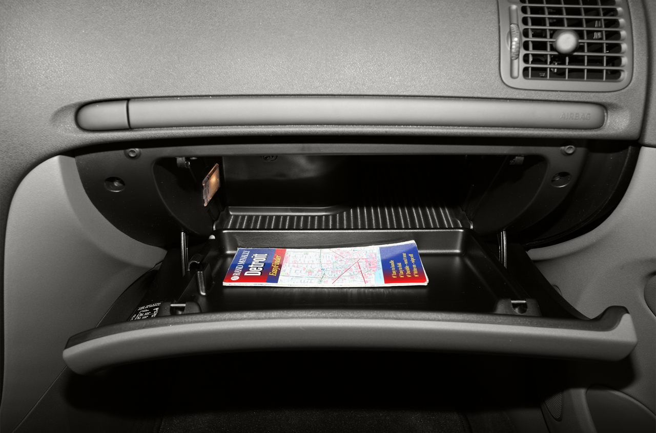 Open glove compartment with map inside