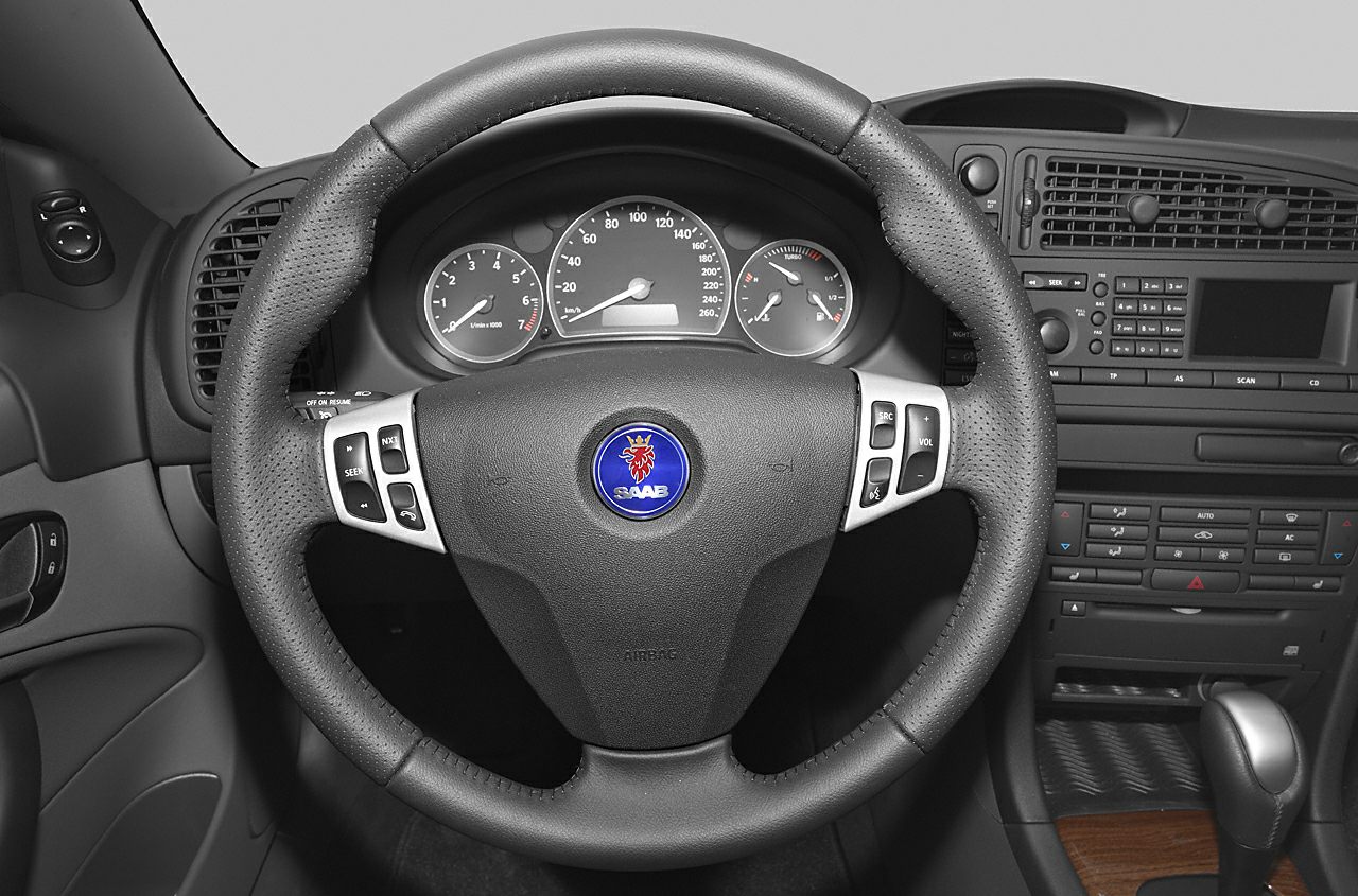 Steering wheel with control buttons and dashboard gauges