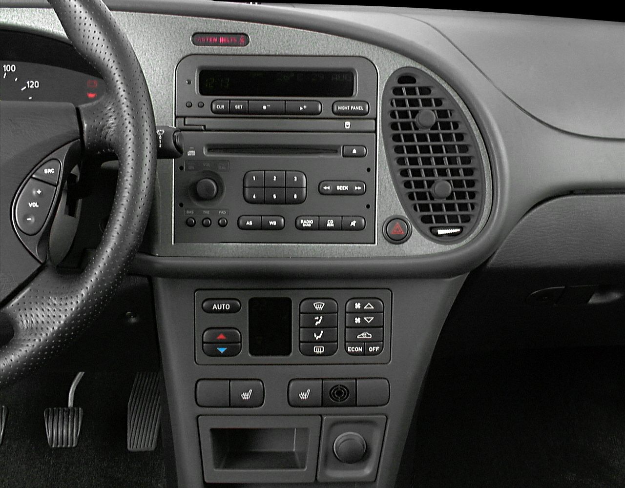 Vintage car dashboard with radio, climate controls, and steering wheel buttons