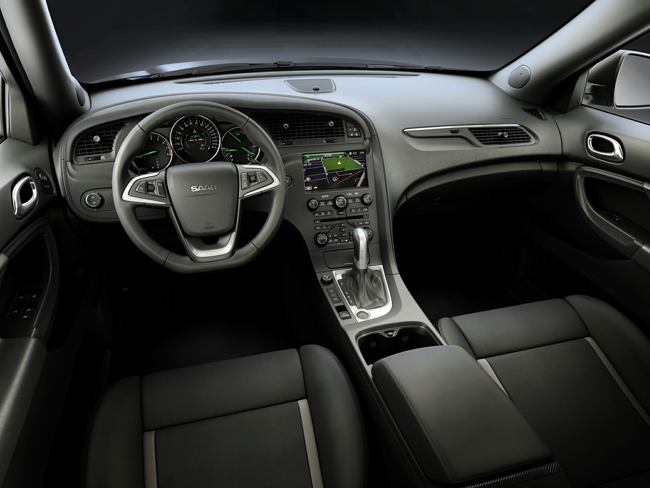 Steering wheel, dashboard with gauges, center console with gear shifter and navigation screen