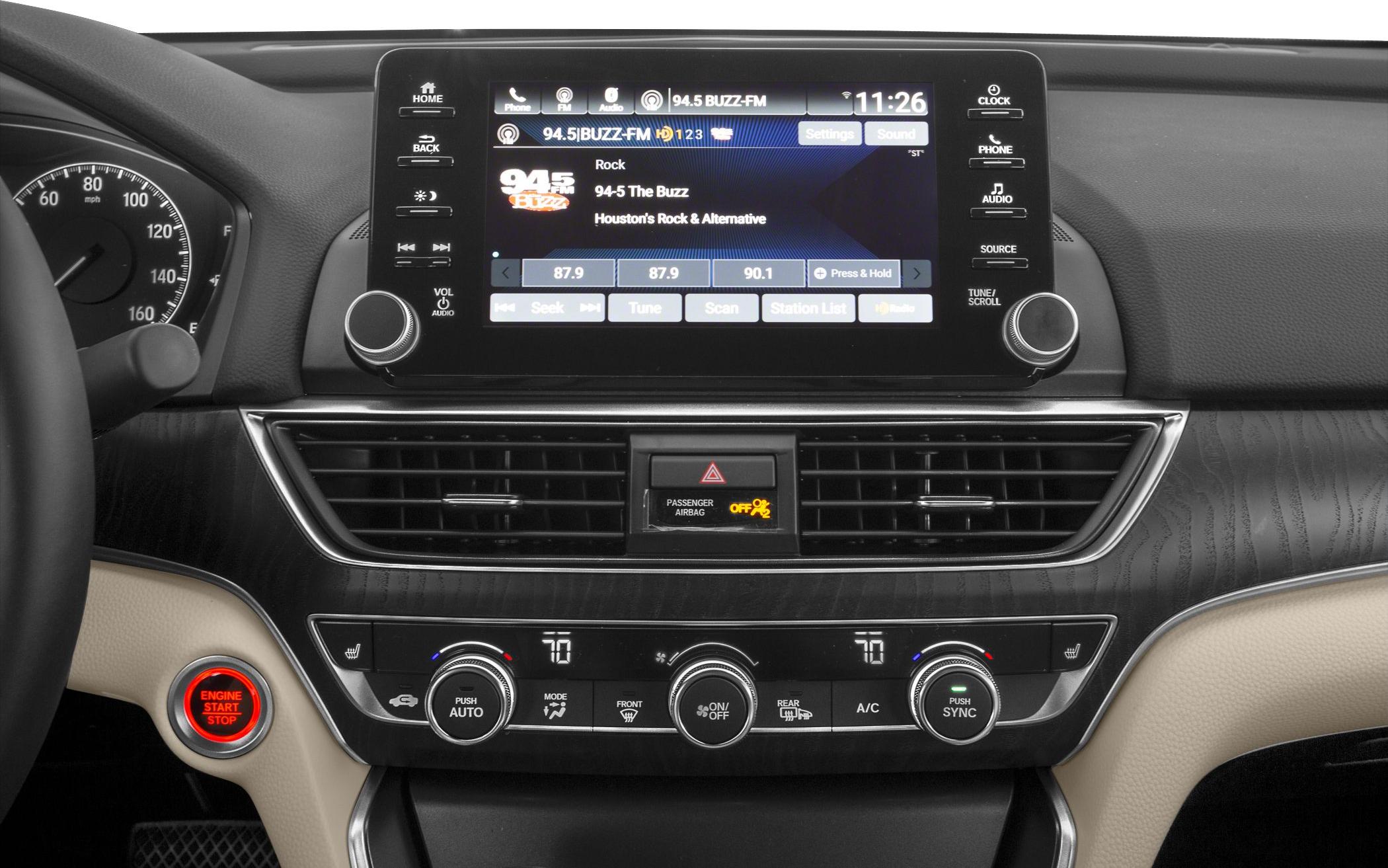 Infotainment touchscreen with climate control knobs and engine start button