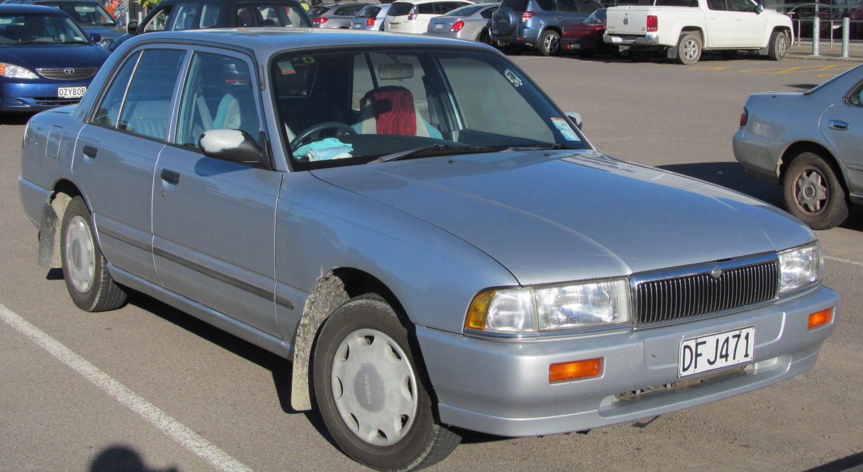 Mid-90s sedan with rectangular headlights and classic grille from front-side angle