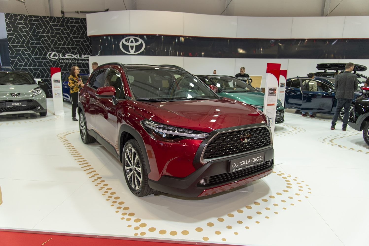 Front view of a red SUV with large black grille and sleek LED headlights