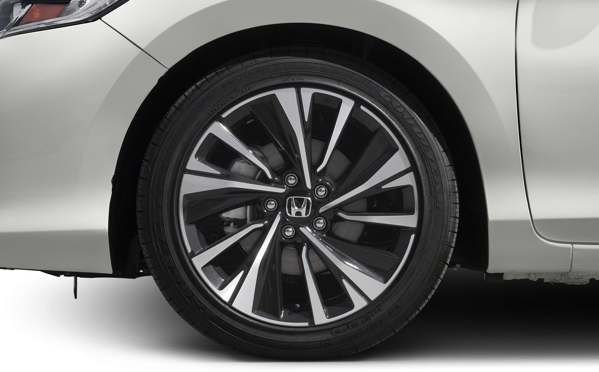 Close-up of alloy wheel with multi-spoke design on a white vehicle.