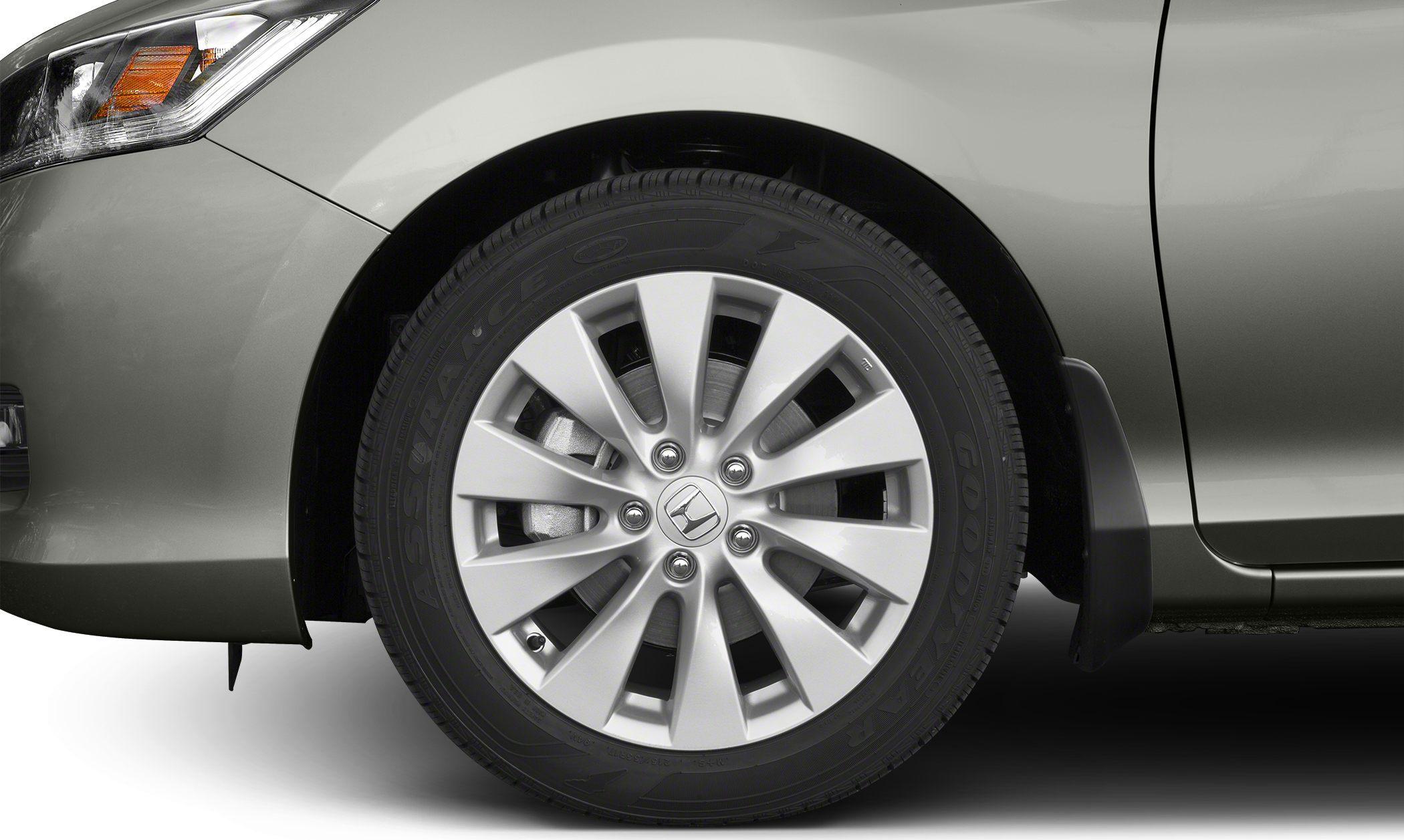 Close-up of alloy wheel and tire with mudguard and headlight