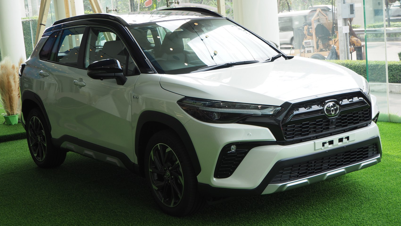 Front side view of modern SUV with LED headlights and aggressive grille