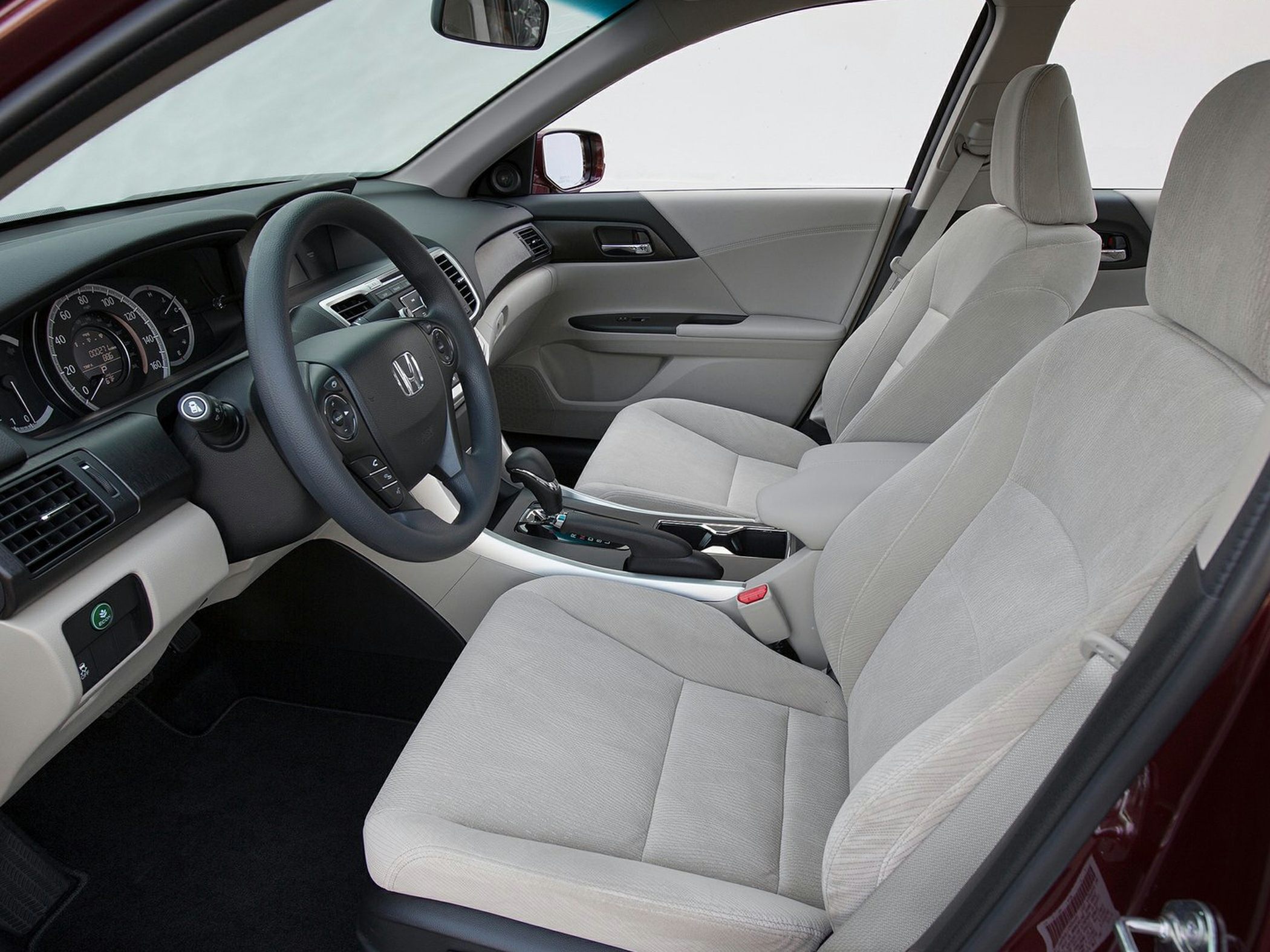 Front interior featuring fabric seats, dashboard, and steering wheel
