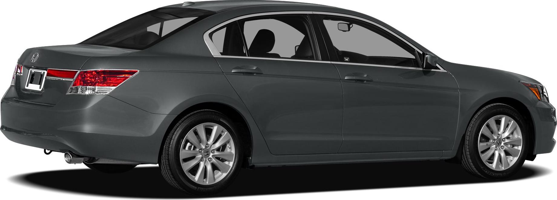 Rear side profile of a sedan with alloy wheels and a visible exhaust pipe.