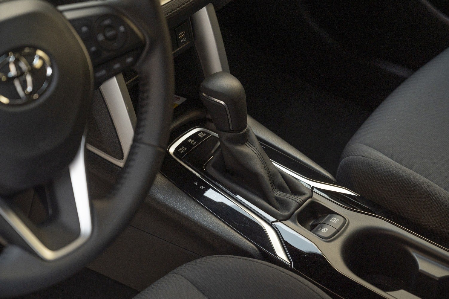 Close-up of gear shift lever and control panel in modern car interior