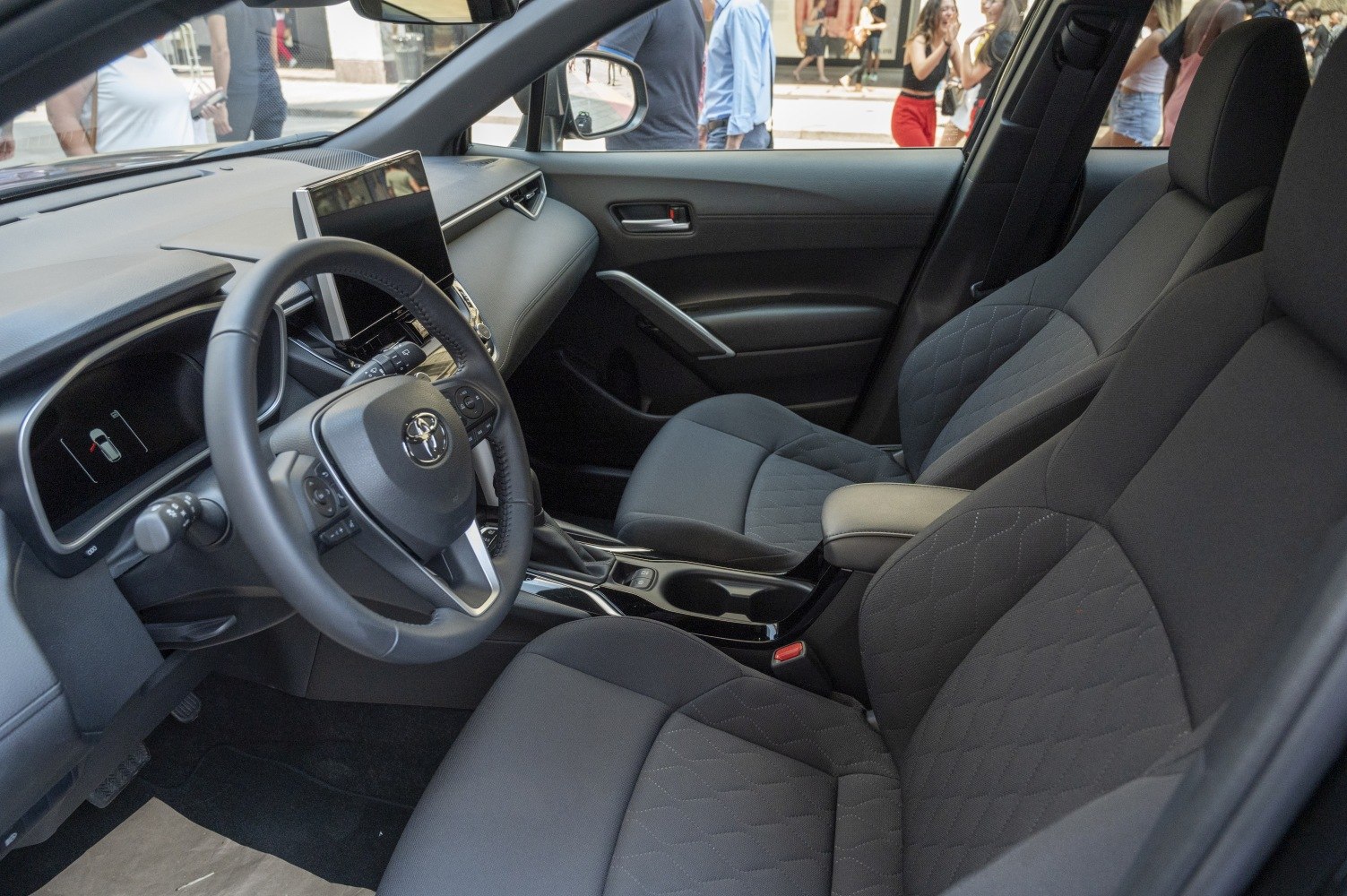 Modern car interior with quilted seats and large digital central display