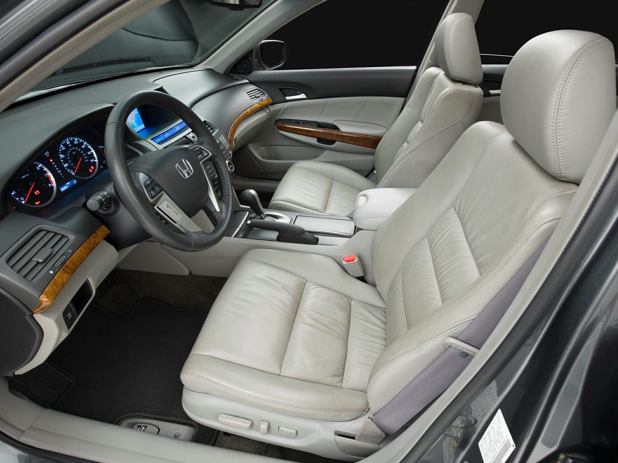 Leather seats and wood trim interior with modern dashboard and automatic gear shift