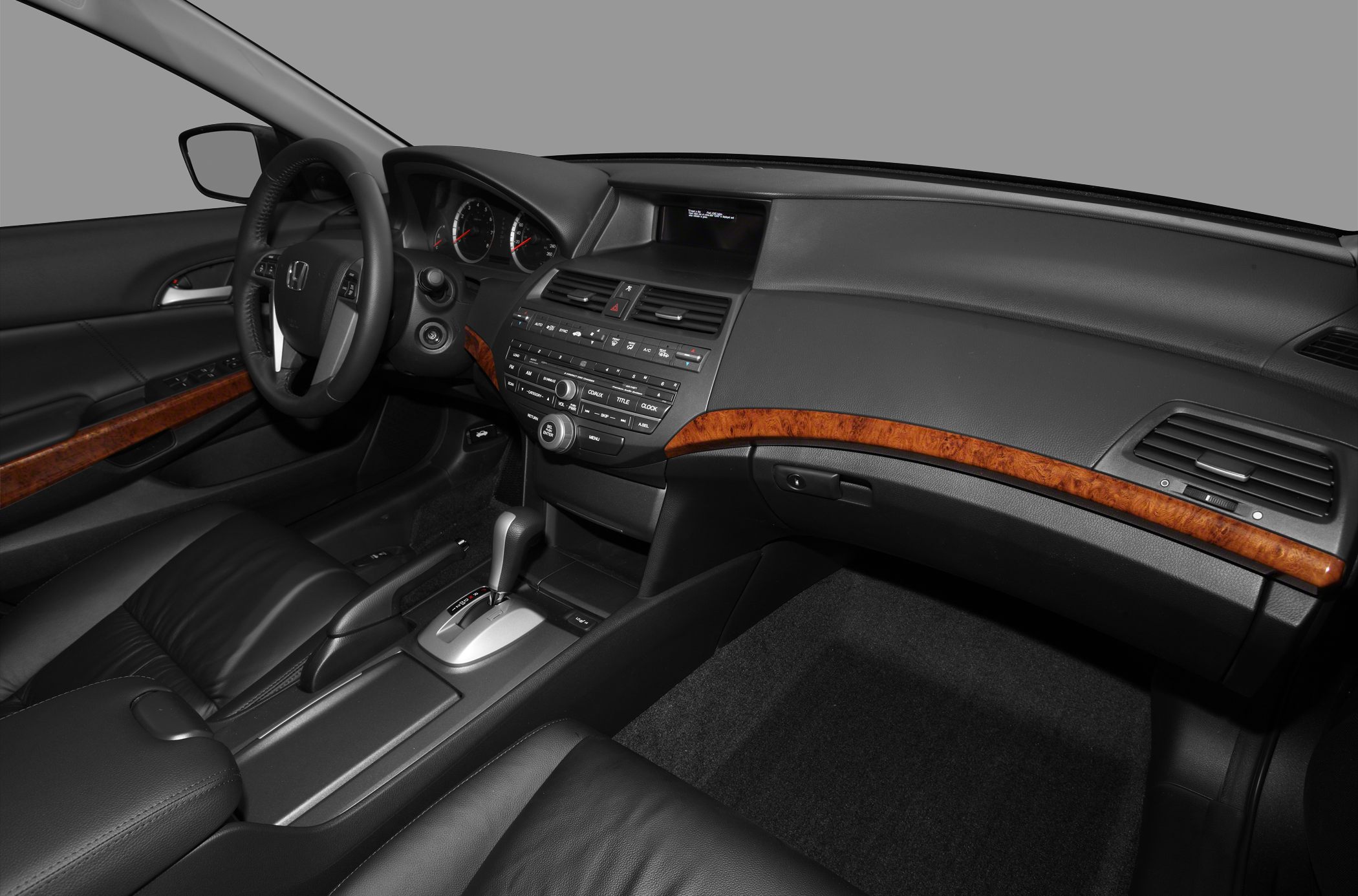 Dashboard with wood trim and leather seats in car interior
