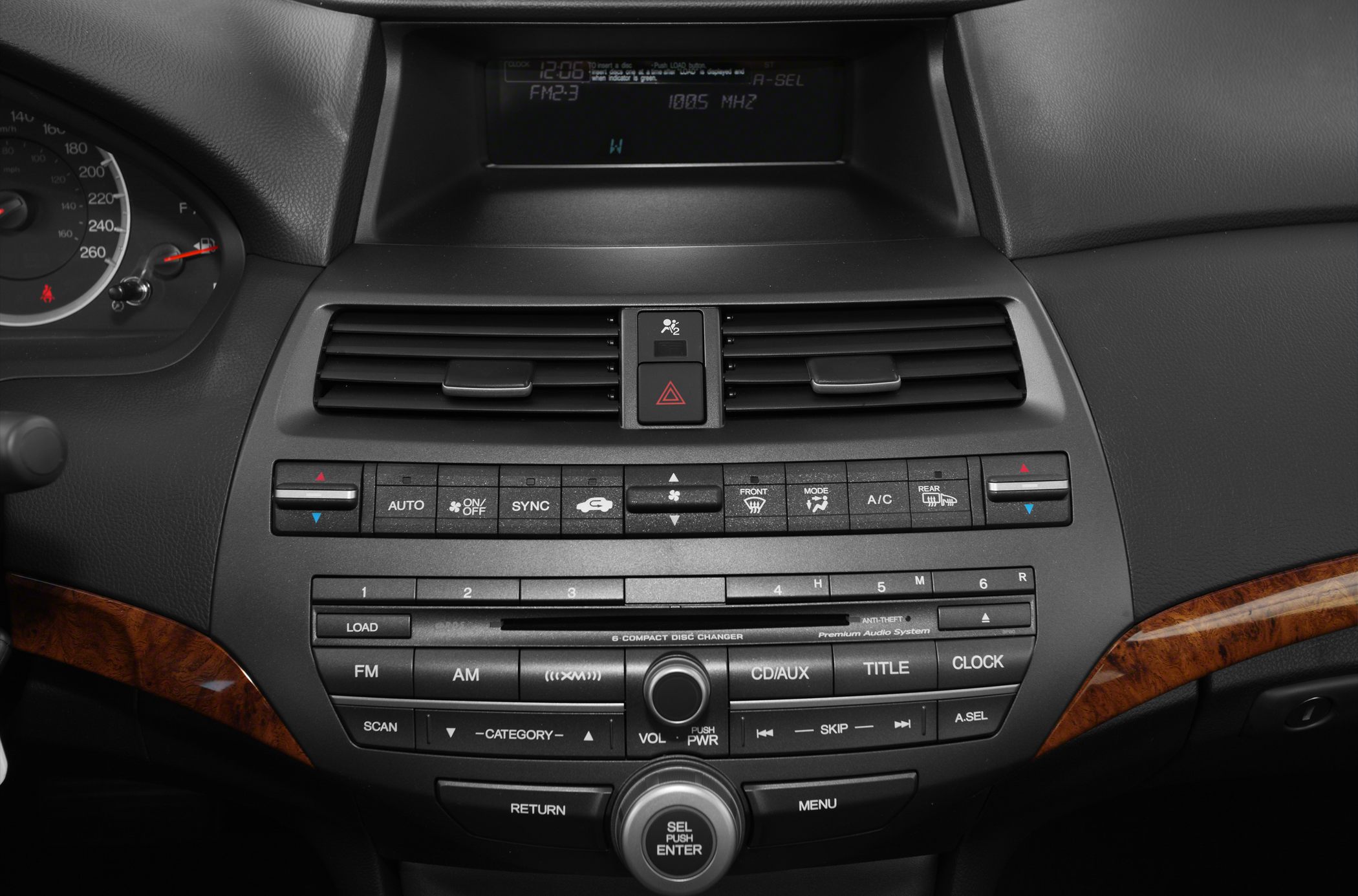 Dashboard center console with climate and audio controls, air vents, and digital display