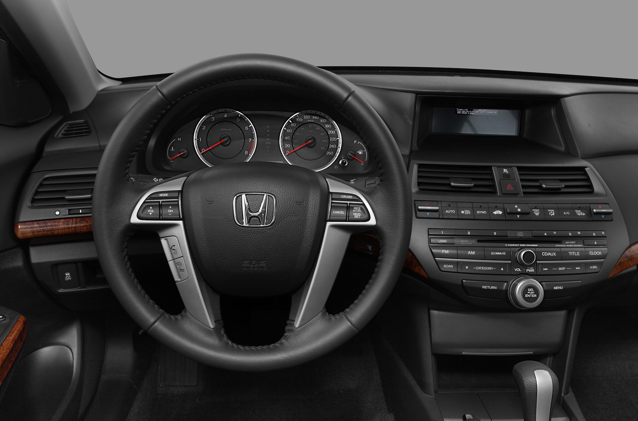 Dashboard and steering wheel with control buttons and instrument cluster