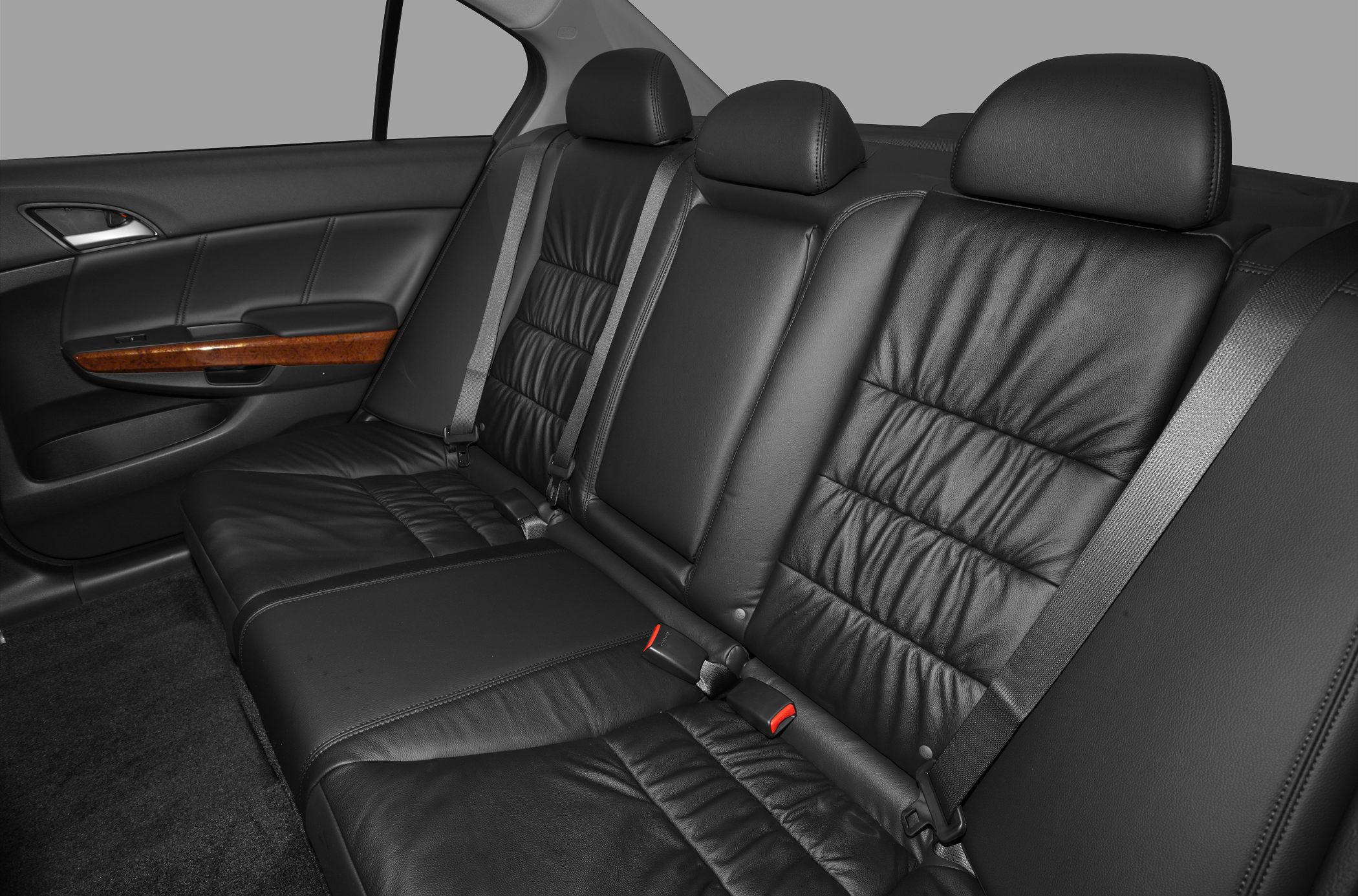 Black leather rear seats with wood trim and seat belts