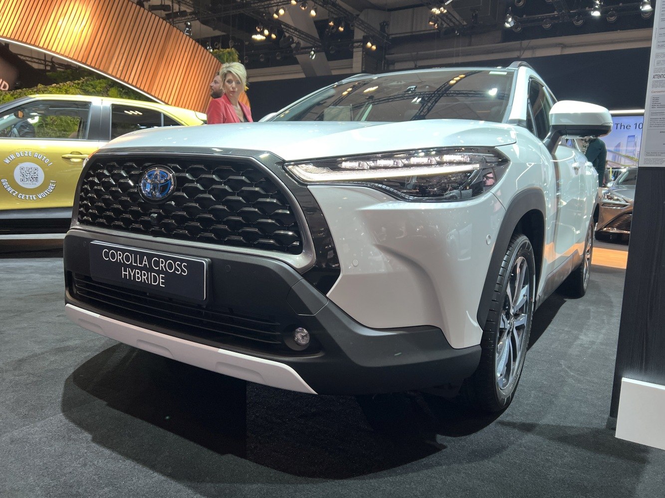 Front grille and LED headlights of a white hybrid SUV