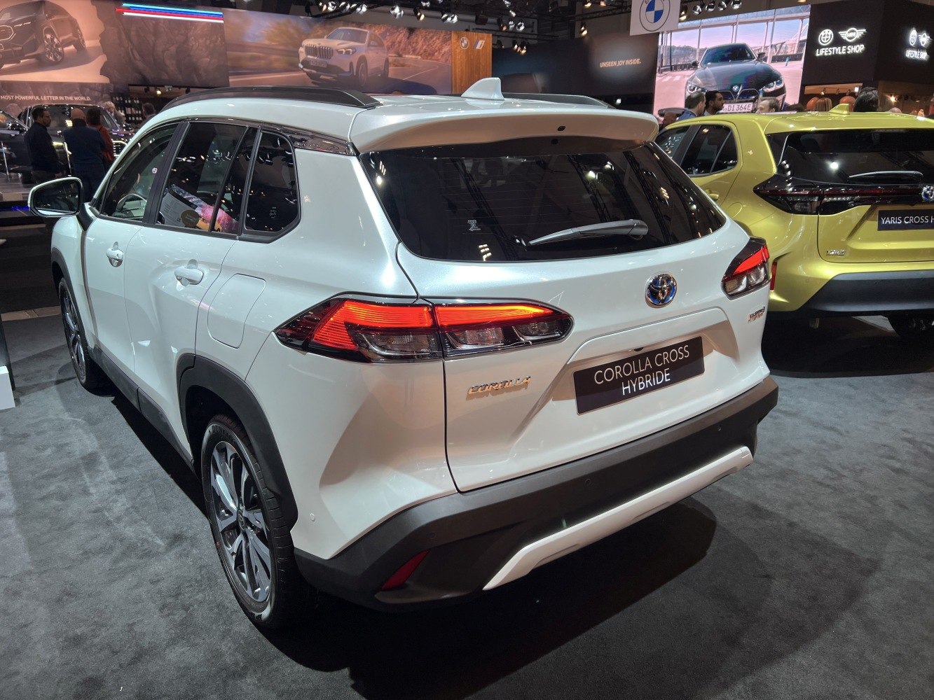 Rear and side profile of a hybrid SUV with distinctive taillights and roof spoiler