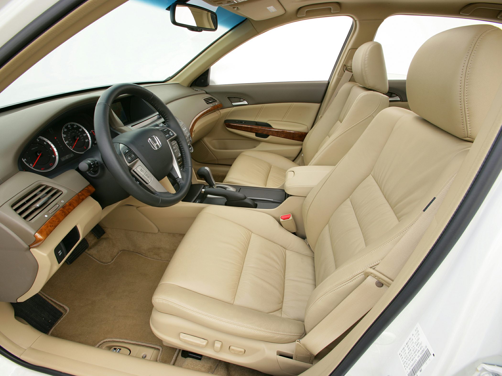 Beige leather seats and wood trim dashboard with multifunction steering wheel