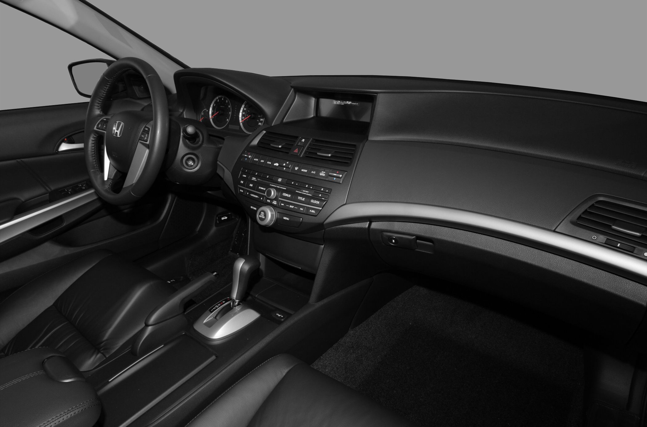 Detailed dashboard, steering wheel, and center console with control buttons.