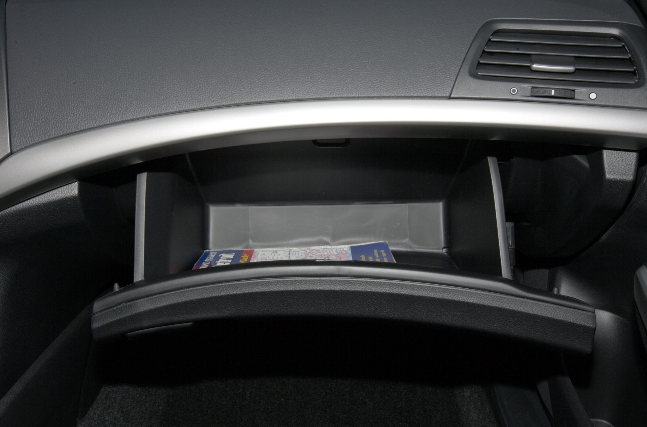 Open glove compartment with visible storage space