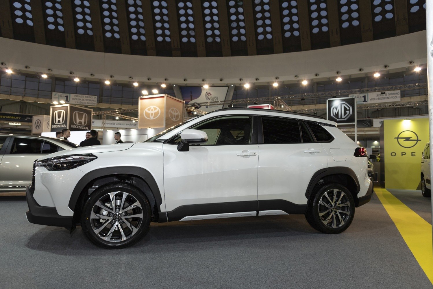 Side profile of white SUV with modern alloy wheels.