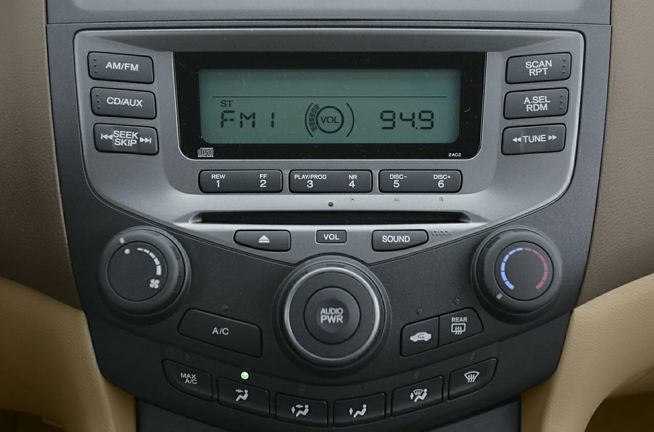 Car audio system with radio, CD player, and climate control knobs
