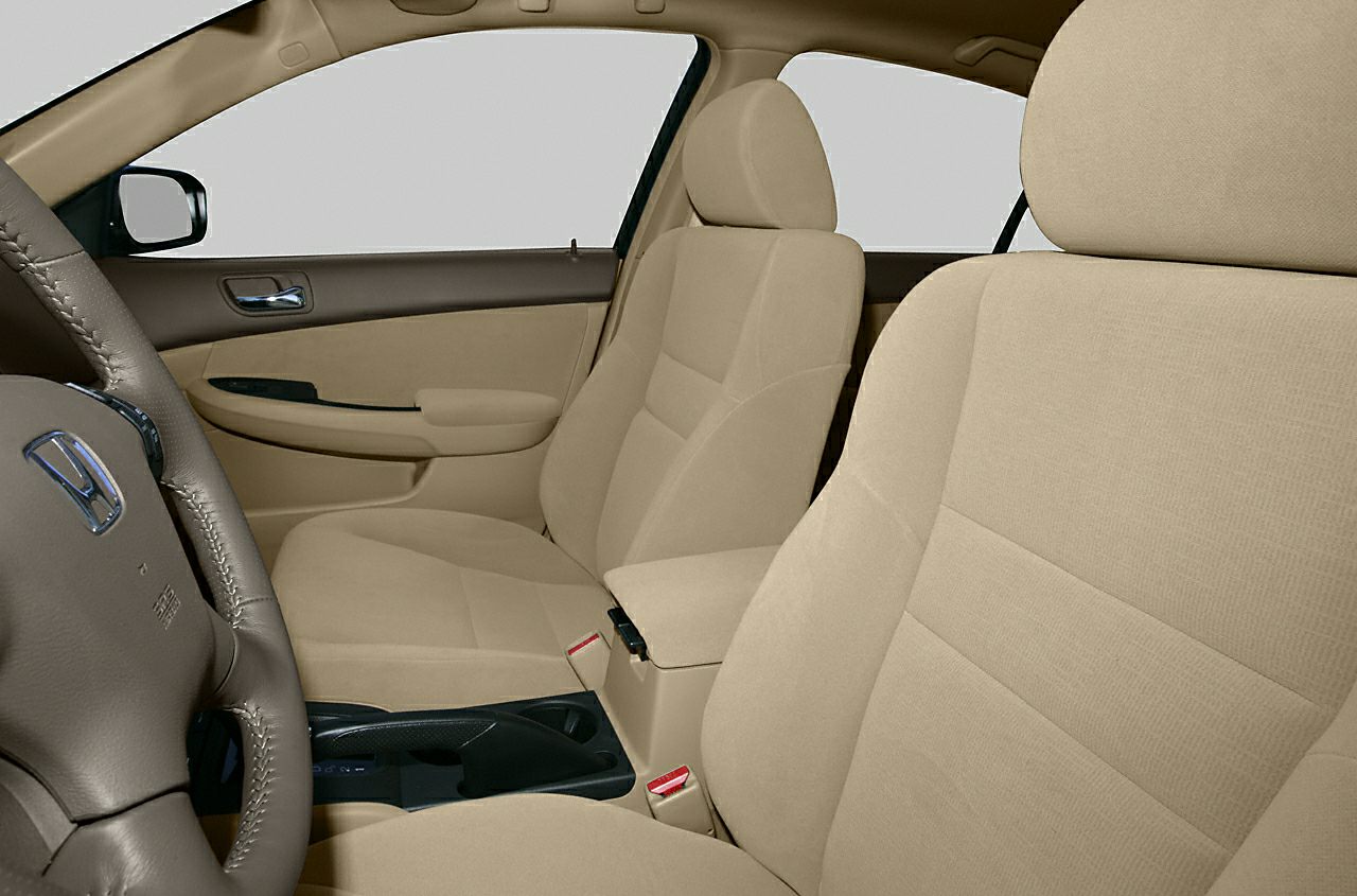 Beige fabric front seats and steering wheel with door panel and center console