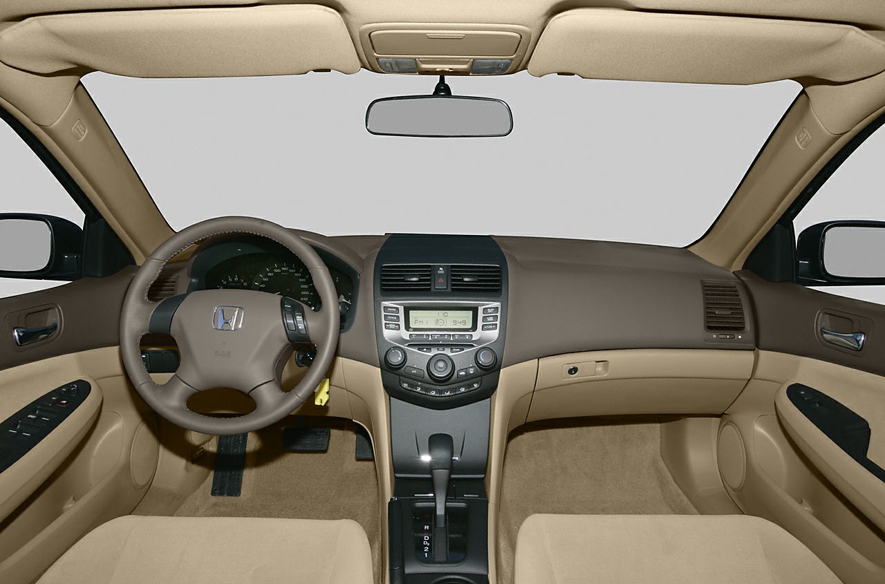 Beige and brown dashboard with steering wheel and center console.