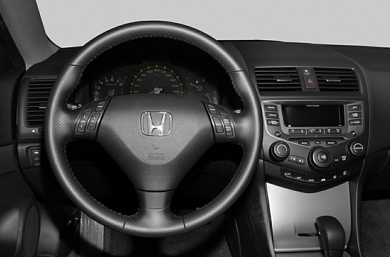 Steering wheel with controls and center console with radio and climate control.
