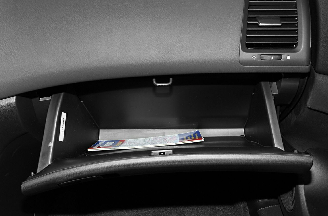 Open glove compartment with a car map inside